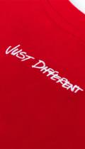 close up of just different embroidered on red mens t shirt