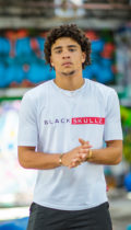 male model wearing white t shirt with blackskullz logo