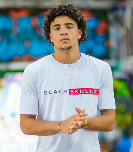 male model wearing white t shirt with blackskullz logo