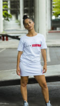 female model wearing long white t shirt with blackskullz logo