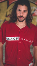 male model in unisex red baseball jersey with embroidered black skullz logo EST 14