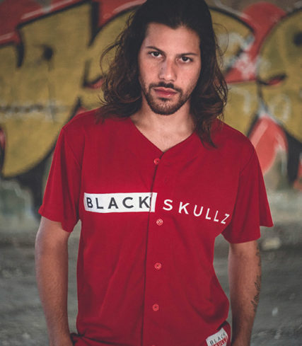 male model in unisex red baseball jersey with embroidered black skullz logo EST 14