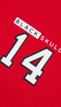 close up of white number 14 and logo on red tshirt