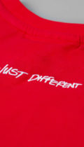 close up of just different white embroidery on red tshirt