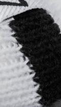 close up of stitching on white beanie