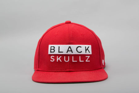 red fitted hat with embroidered black skullz logo