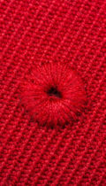 close up of stiching on red fitted cap