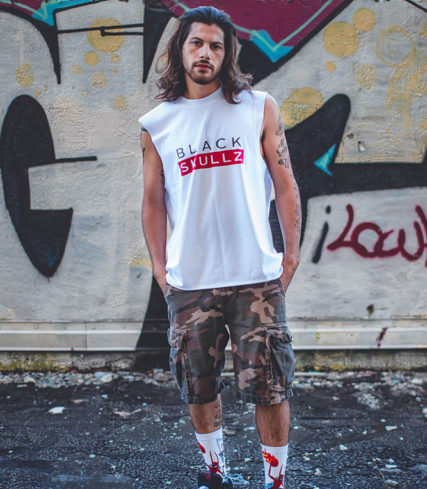 male model wearing white blackskullz brand label tank and camo shorts